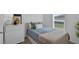 Cozy bedroom featuring a twin bed, dresser, and a window, providing a comfortable space at 12835 Del Lago Dr, Astatula, FL 34705