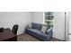 Office featuring a pullout couch and pillows, with natural light from the window at 12835 Del Lago Dr, Astatula, FL 34705