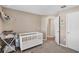 Cozy Bedroom featuring a white crib and changing table, perfect for a young Gathering at 12835 Del Lago Dr, Astatula, FL 34705