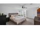 Comfortable main bedroom with a ceiling fan, carpet floors, and attached bath access at 12835 Del Lago Dr, Astatula, FL 34705