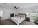 Comfortable main bedroom with a ceiling fan, carpet floors, and natural light from the windows at 12835 Del Lago Dr, Astatula, FL 34705