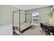 Light and airy bedroom with canopy bed, desk, and ample natural light, a cozy and functional space at 12835 Del Lago Dr, Astatula, FL 34705