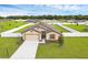 Charming single-Gathering home with well-maintained landscaping, inviting curb appeal, and an attached two car garage at 12835 Del Lago Dr, Astatula, FL 34705