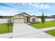 Charming single-story home with a well-manicured lawn and two car garage at 12835 Del Lago Dr, Astatula, FL 34705
