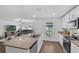 Open kitchen with stainless appliances, granite countertops, seamlessly connected to the living room at 12835 Del Lago Dr, Astatula, FL 34705