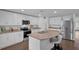 Bright kitchen with stainless steel appliances, granite countertops, and an island with seating at 12835 Del Lago Dr, Astatula, FL 34705