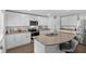 Modern kitchen features a peninsula island with bar seating and stainless steel appliances at 12835 Del Lago Dr, Astatula, FL 34705