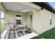 Covered outdoor patio, with an outdoor dining set, overlooking the backyard at 12835 Del Lago Dr, Astatula, FL 34705