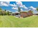 Well-maintained lawn with rear patio, providing a private and inviting outdoor retreat at 1288 Americana Pl, Orlando, FL 32807