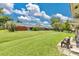 Expansive backyard with well-manicured lawn and mature trees, offering a serene outdoor space at 1288 Americana Pl, Orlando, FL 32807