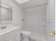 Bright bathroom featuring a white vanity, toilet, and a walk-in shower, creating a clean and modern space at 1288 Americana Pl, Orlando, FL 32807