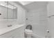Bright bathroom featuring a white vanity, toilet, and a walk-in shower, creating a clean and modern space at 1288 Americana Pl, Orlando, FL 32807