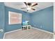 Cozy bedroom with blue walls, modern vinyl plank flooring, and a ceiling fan at 1288 Americana Pl, Orlando, FL 32807