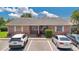 Charming brick facade with assigned parking spaces, creating curb appeal and convenience at 1288 Americana Pl, Orlando, FL 32807