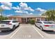 Charming brick duplex features a well-maintained facade with dedicated parking spaces for residents and guests at 1288 Americana Pl, Orlando, FL 32807