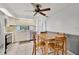 Eat-in kitchen features white cabinets, stainless steel appliances, and a tiled floor at 1288 Americana Pl, Orlando, FL 32807
