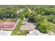 Aerial view of the tennis and basketball court area, playground, boat parking, and storage sheds at 1288 Americana Pl, Orlando, FL 32807