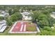 Aerial view of the community recreation area with basketball court, playground, and common house with pool at 1288 Americana Pl, Orlando, FL 32807