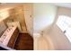 Bathroom with double sink vanity, soaking tub, wood floors, and a gold trimmed shower at 130 Winsor Ave, Davenport, FL 33837