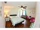 Spacious bedroom with ceiling fan and hardwood flooring at 130 Winsor Ave, Davenport, FL 33837