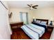 Cozy bedroom featuring a bed and hardwood flooring at 130 Winsor Ave, Davenport, FL 33837