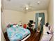 Comfortable bedroom with a ceiling fan and desk at 130 Winsor Ave, Davenport, FL 33837