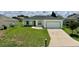 Attractive home featuring a lush lawn, stone accents, and an attached two-car garage at 130 Winsor Ave, Davenport, FL 33837