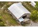Spacious metal building with covered porch and ample parking space, set on a well-maintained grassy lot at 1443 Stone Trl, Enterprise, FL 32725