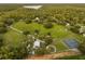 Sprawling rural property with a large field, horse paddock, tennis courts, and various outbuildings at 1443 Stone Trl, Enterprise, FL 32725