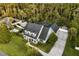 Aerial view of a house with a large yard surrounded by lush trees at 1443 Stone Trl, Enterprise, FL 32725
