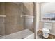 Bathtub and shower combo, complete with modern fixtures, within the bathroom at 1443 Stone Trl, Enterprise, FL 32725