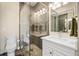 Modern bathroom featuring a glass-enclosed shower, patterned tile floors, and a stylish vanity at 1443 Stone Trl, Enterprise, FL 32725