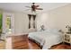 Bedroom features a ceiling fan, hardwood floors, and door leading to an outdoor patio at 1443 Stone Trl, Enterprise, FL 32725