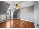Spacious bedroom with hardwood floors, neutral gray walls, ceiling fan, and window at 1443 Stone Trl, Enterprise, FL 32725