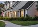 Stylish home featuring a covered front porch with elegant columns, lush landscaping, and a neatly trimmed lawn at 1443 Stone Trl, Enterprise, FL 32725