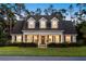 Charming two-story home featuring a welcoming front porch, manicured lawn, and well-maintained landscaping at 1443 Stone Trl, Enterprise, FL 32725