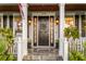 Inviting front entrance featuring a charming black door, elegant sidelights, a cozy wreath, and stylish porch decor at 1443 Stone Trl, Enterprise, FL 32725