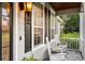Inviting front porch featuring rocking chairs and brick flooring at 1443 Stone Trl, Enterprise, FL 32725