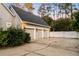 Exterior of a three-car garage featuring updated lighting and a well-maintained driveway at 1443 Stone Trl, Enterprise, FL 32725