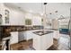 Modern kitchen with white cabinets, stainless steel appliances, granite countertops, and a kitchen island at 1443 Stone Trl, Enterprise, FL 32725