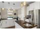 Bright kitchen features stainless steel appliances, granite countertops, and pendant lighting at 1443 Stone Trl, Enterprise, FL 32725