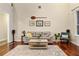 Bright living room with hardwood floors, comfortable seating and artwork at 1443 Stone Trl, Enterprise, FL 32725