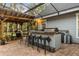 Outdoor kitchen with bar seating, built-in grill, and a dining area under a pergola at 1443 Stone Trl, Enterprise, FL 32725
