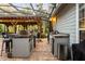 Outdoor kitchen equipped with a grill, counter space, and bar seating, perfect for outdoor dining at 1443 Stone Trl, Enterprise, FL 32725