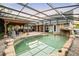 Sparkling pool with rock features, surrounded by a screened enclosure and a brick patio at 1443 Stone Trl, Enterprise, FL 32725