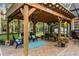 Outdoor patio featuring a covered pergola with lounge chairs and a dining table overlooking the lush landscaping at 1443 Stone Trl, Enterprise, FL 32725