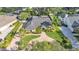 An aerial view of a well-manicured home showcasing its spacious lot and inviting pool area at 1455 Royal Forest Loop, Lakeland, FL 33811