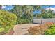 Secluded backyard featuring a brick patio, established shrubbery and a privacy fence at 1455 Royal Forest Loop, Lakeland, FL 33811