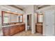 Bathroom featuring dual vanities, granite countertops, and wood cabinets at 1455 Royal Forest Loop, Lakeland, FL 33811