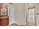 Bathroom with a vanity, mirror and lighting with entryways on either side at 1455 Royal Forest Loop, Lakeland, FL 33811